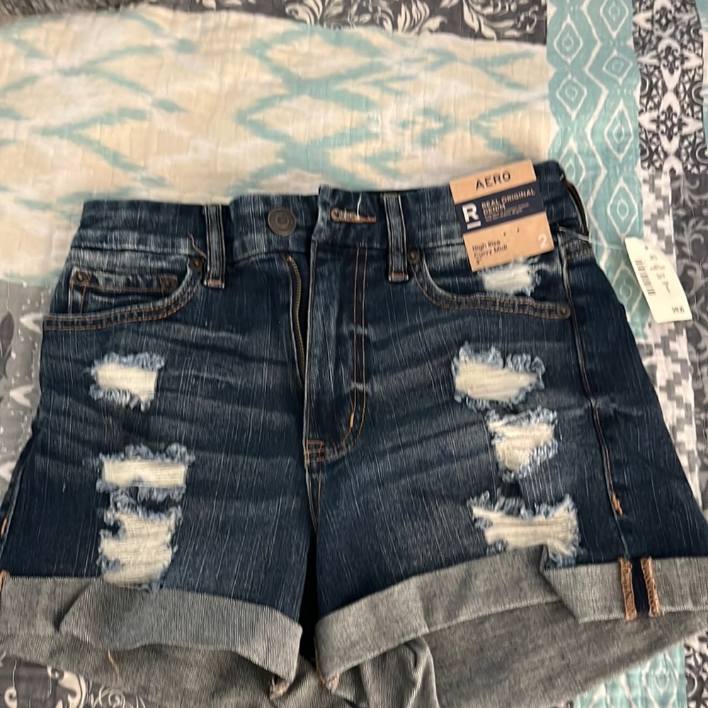 They are high rise dark denim blue jean shorts.